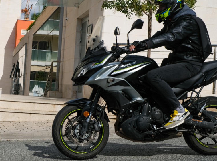 motorcyclist passing urban street
