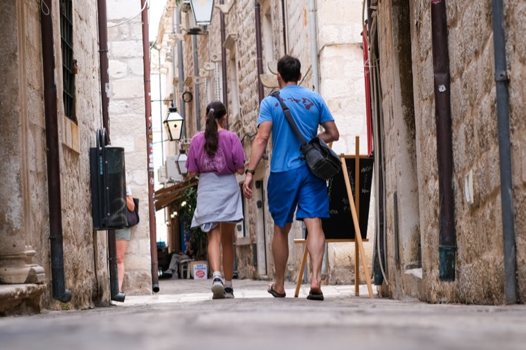 couple walking narrow alley