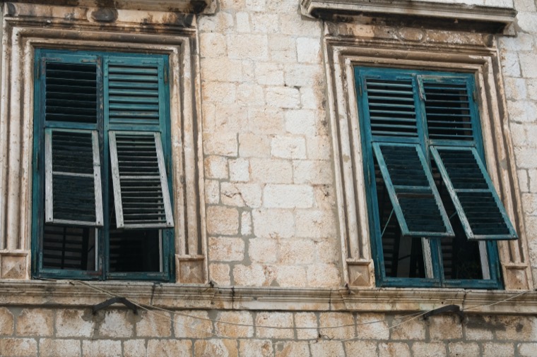 weathered shuttered stone windows