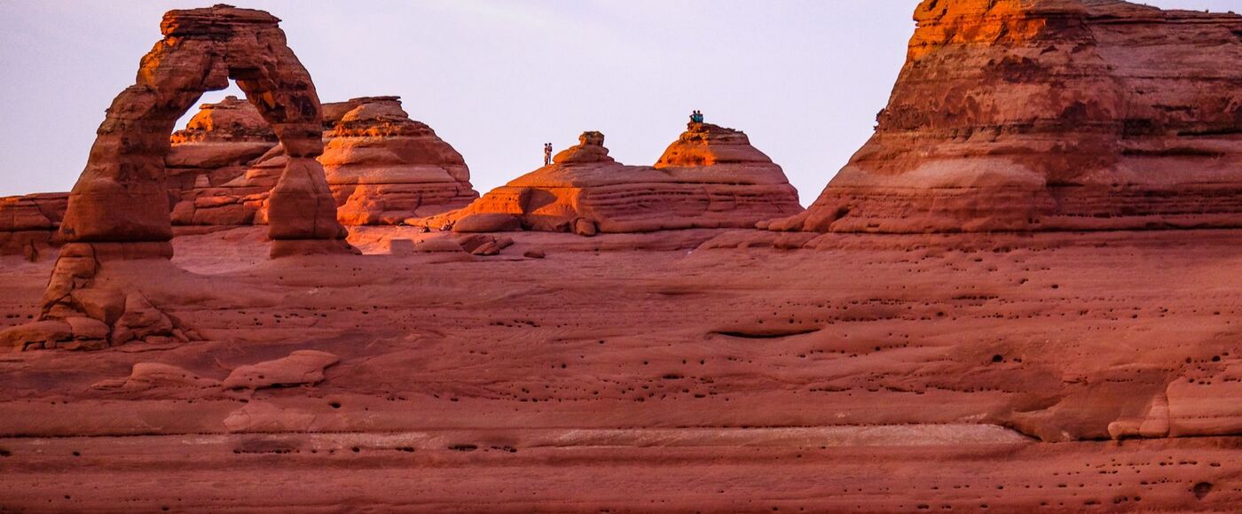 Delicate Arch glowing red at sunset in Arches National Park, Utah